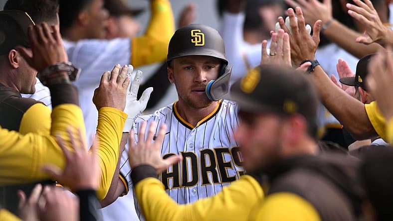 Aug 3, 2022; San Diego, California, USA; San Diego Padres designated hitter Brandon Drury (center) is congratulated in the dugout after hitting a grand slam home run during the first inning against the Colorado Rockies at Petco Park. Mandatory Credit: Orlando Ramirez-USA TODAY Sports