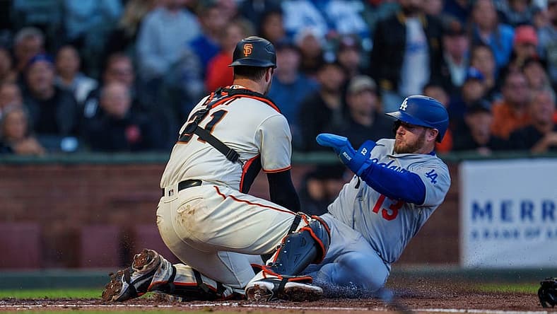 Aug 3, 2022; San Francisco, California, USA;  Los Angeles Dodgers third baseman Max Muncy (13) slides in safely against San Francisco Giants catcher Joey Bart (21) during the fourth inning at Oracle Park. Mandatory Credit: Neville E. Guard-USA TODAY Sports