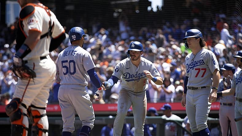 Aug 4, 2022; San Francisco, California, USA; Los Angeles Dodgers right fielder Mookie Betts (50) is greeted by teammates Gavin Lux (9) and James Outman (77) after hitting a three-run home run against the San Francisco Giants during the fourth inning at Oracle Park. Mandatory Credit: D. Ross Cameron-USA TODAY Sports