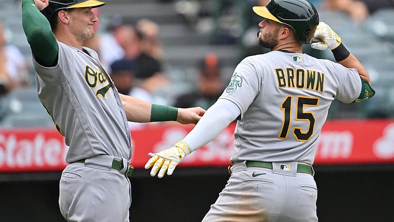Aug 4, 2022; Anaheim, California, USA; Oakland Athletics first baseman Seth Brown (15) is congratulated by designated hitter Sean Murphy (12) after hitting a two run home run in the third inning against the Los Angeles Angels at Angel Stadium. Mandatory Credit: Jayne Kamin-Oncea-USA TODAY Sports