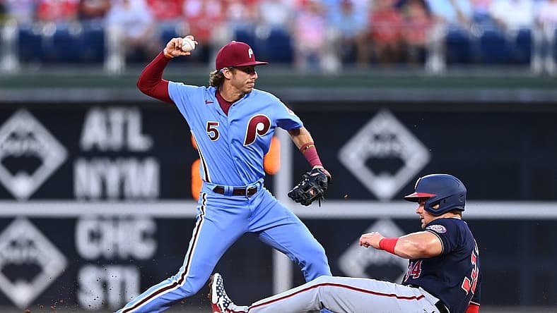 Aug 4, 2022; Philadelphia, Pennsylvania, USA; Philadelphia Phillies infielder Bryson Stott (5) attempts to turn a double play over Washington Nationals first baseman Luke Voit (34) in the first inning at Citizens Bank Park. Mandatory Credit: Kyle Ross-USA TODAY Sports