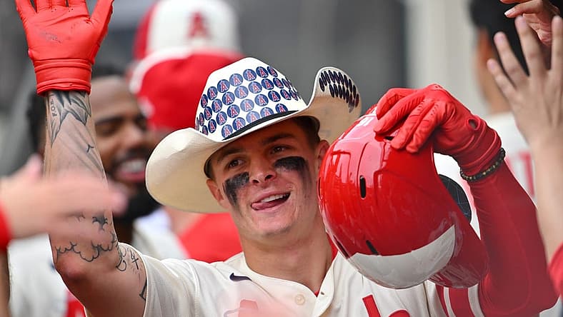 Aug 4, 2022; Anaheim, California, USA; Los Angeles Angels center fielder Mickey Moniak (16) is congratulated in the dugout after hitting his first major league home run in the ninth inning against the Oakland Athletics at Angel Stadium. Mandatory Credit: Jayne Kamin-Oncea-USA TODAY Sports
