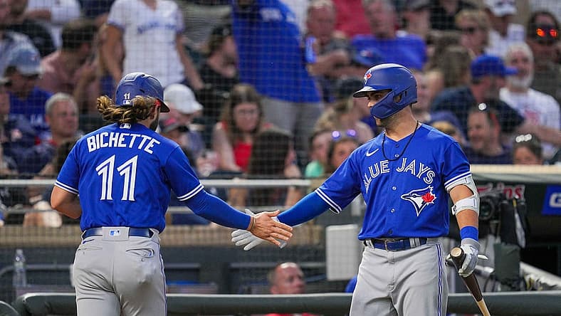Aug 4, 2022; Minneapolis, Minnesota, USA; Toronto Blue Jays center fielder Whit Merrifield (1) congratulates shortstop Bo Bichette (11) after scoring against the Minnesota Twins in the sixth inning at Target Field. Mandatory Credit: Brad Rempel-USA TODAY Sports
