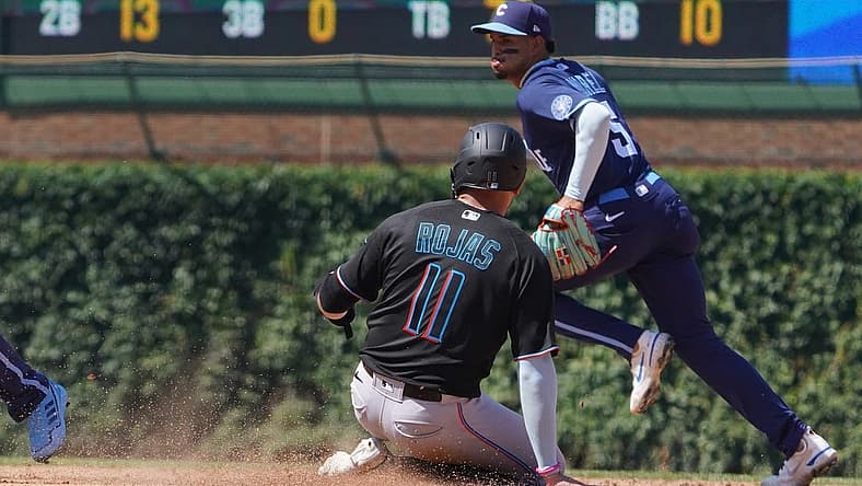 Aug 5, 2022; Chicago, Illinois, USA; Miami Marlins shortstop Miguel Rojas (11) steals second base as Chicago Cubs shortstop Christopher Morel (5) covers the base during the fifth inning at Wrigley Field. Mandatory Credit: David Banks-USA TODAY Sports
