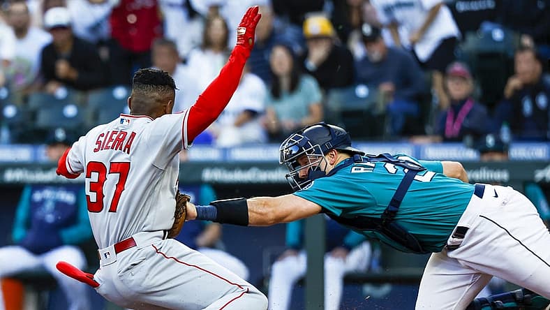 Aug 5, 2022; Seattle, Washington, USA; Seattle Mariners catcher Cal Raleigh (29) tags out Los Angeles Angels center fielder Magneuris Sierra (37) on an attempt to score on an inside-the-park homerun during the second inning at T-Mobile Park. Mandatory Credit: Joe Nicholson-USA TODAY Sports
