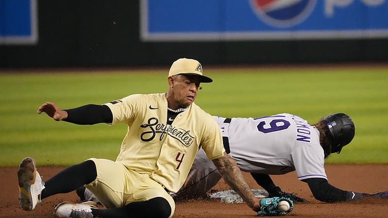 Aug 5, 2022; Phoenix, Arizona, USA; Colorado Rockies designated hitter Charlie Blackmon (19) beats a throw to Arizona Diamondbacks second baseman Ketel Marte (4) to steal second base during the fifth inning at Chase Field. Mandatory Credit: Joe Camporeale-USA TODAY Sports
