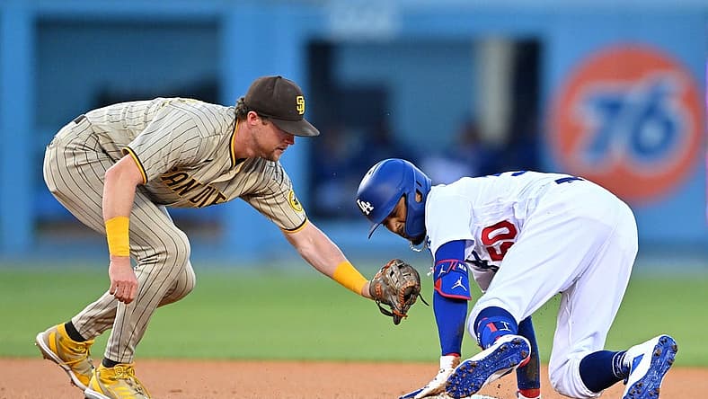 Aug 5, 2022; Los Angeles, California, USA; Los Angeles Dodgers right fielder Mookie Betts (50) is safe at second as he beats the tag by San Diego Padres second baseman Jake Cronenworth (9) in the first inning at Dodger Stadium. Mandatory Credit: Jayne Kamin-Oncea-USA TODAY Sports