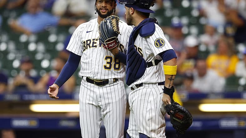 Aug 5, 2022; Milwaukee, Wisconsin, USA; Milwaukee Brewers pitcher Devin Williams (38) talks with catcher Victor Caratini (7) during the ninth inning against the Cincinnati Reds at American Family Field. Mandatory Credit: Jeff Hanisch-USA TODAY Sports