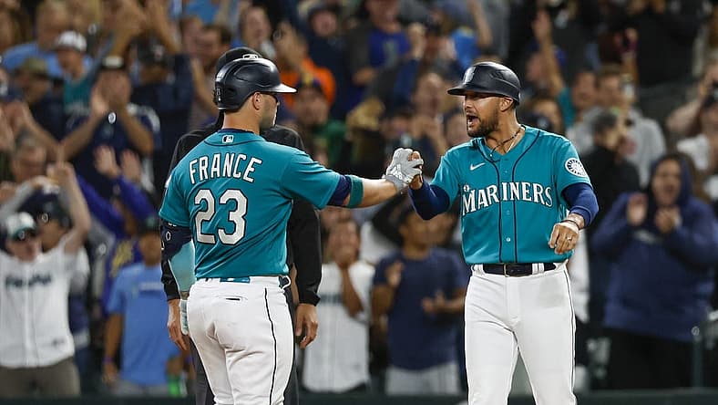 Aug 5, 2022; Seattle, Washington, USA; Seattle Mariners first baseman Ty France (23) celebrates with first base coach Kristopher Negron (45) after hitting a two-run single against the Los Angeles Angels during the ninth inning at T-Mobile Park. Mandatory Credit: Joe Nicholson-USA TODAY Sports