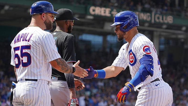 Aug 6, 2022; Chicago, Illinois, USA; Chicago Cubs designated hitter Willson Contreras (40) is greeted by first base coach Mike Napoli (55) after hitting a one run single against the Miami Marlins during the fifth inning at Wrigley Field. Mandatory Credit: David Banks-USA TODAY Sports