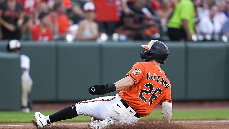 Aug 6, 2022; Baltimore, Maryland, USA; Baltimore Orioles left fielder Ryan McKenna (26) slides into third base after a pickoff error by Pittsburgh Pirates relief pitcher Eric Stout (not pictured) in the fifth inning at Oriole Park at Camden Yards. Mandatory Credit: Brent Skeen-USA TODAY Sports