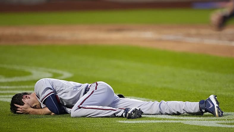 Aug 6, 2022; New York City, New York, USA; Atlanta Braves pitcher Max Fried (54) lies on the ground after a play against the New York Mets during the third inning at Citi Field. Mandatory Credit: Gregory Fisher-USA TODAY Sports