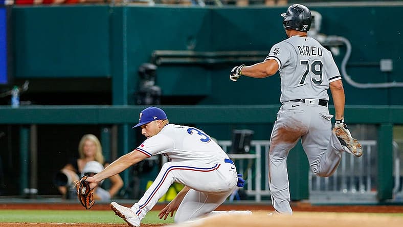 Aug 6, 2022; Arlington, Texas, USA; Chicago White Sox first baseman Jose Abreu (79) beats out a double play against Texas Rangers first baseman Nathaniel Lowe (30) during the fourth inning at Globe Life Field. Mandatory Credit: Andrew Dieb-USA TODAY Sports