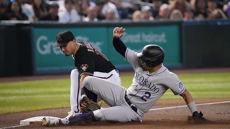 Aug 6, 2022; Phoenix, Arizona, USA; Colorado Rockies center fielder Yonathan Daza (2) beats the tag of Arizona Diamondbacks third baseman Josh Rojas (10) at third base during the third inning at Chase Field. Mandatory Credit: Joe Camporeale-USA TODAY Sports