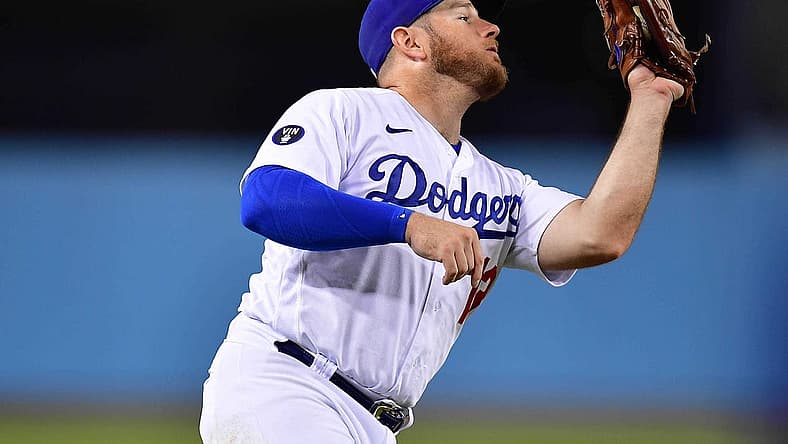 Aug 6, 2022; Los Angeles, California, USA; Los Angeles Dodgers third baseman Max Muncy (13) catches the fly ball of San Diego Padres first baseman Josh Bell (24) during the eighth inning at Dodger Stadium. Mandatory Credit: Gary A. Vasquez-USA TODAY Sports