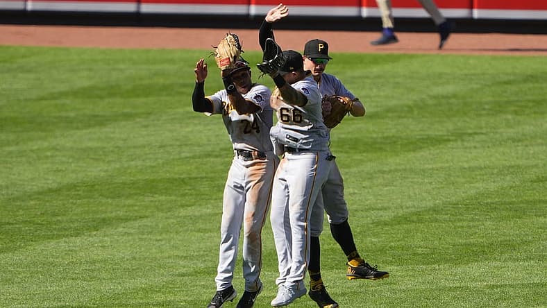 Aug 7, 2022; Baltimore, Maryland, USA; Pittsburgh Pirates left fielder Greg Allen (24) and right fielder Bligh Madris (66) and center fielder Bryan Reynolds (10) celebrate after defeating the Baltimore Orioles at Oriole Park at Camden Yards. Mandatory Credit: Gregory Fisher-USA TODAY Sports