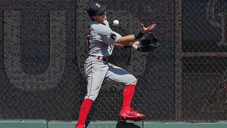 Aug 7, 2022; Kansas City, Missouri, USA; Boston Red Sox center fielder Jarren Duran (40) is unable to make the catch at the wall during the eighth inning against the Kansas City Royals at Kauffman Stadium. Mandatory Credit: Jay Biggerstaff-USA TODAY Sports