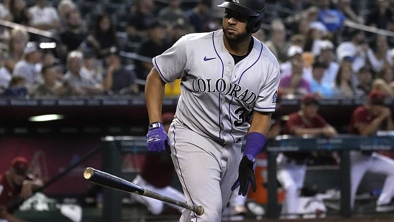 Aug 7, 2022; Phoenix, Arizona, USA; Colorado Rockies catcher Elias Diaz (35) tosses his bat after drawing a walk against the Arizona Diamondbacks in the sixth inning at Chase Field. Mandatory Credit: Rick Scuteri-USA TODAY Sports