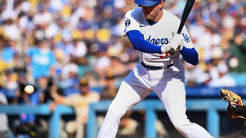 Aug 7, 2022; Los Angeles, California, USA; Los Angeles Dodgers first baseman Freddie Freeman (5) hits an RBI single against the San Diego Padres during third inning at Dodger Stadium. Mandatory Credit: Jonathan Hui-USA TODAY Sports