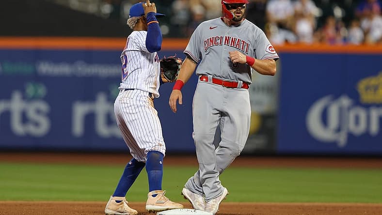 Aug 8, 2022; New York City, New York, USA; Cincinnati Reds first baseman Mike Moustakas (9) is out at second base by New York Mets shortstop Francisco Lindor (12) during the fourth inning at Citi Field. Mandatory Credit: Vincent Carchietta-USA TODAY Sports