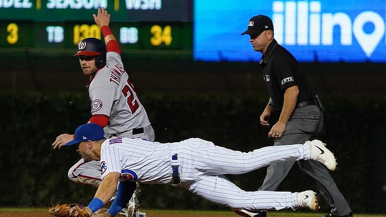 Aug 8, 2022; Chicago, Illinois, USA; Washington Nationals right fielder Lane Thomas (28) is safe at second base against Chicago Cubs shortstop Nico Hoerner (2) during the fifth inning at Wrigley Field. Mandatory Credit: David Banks-USA TODAY Sports