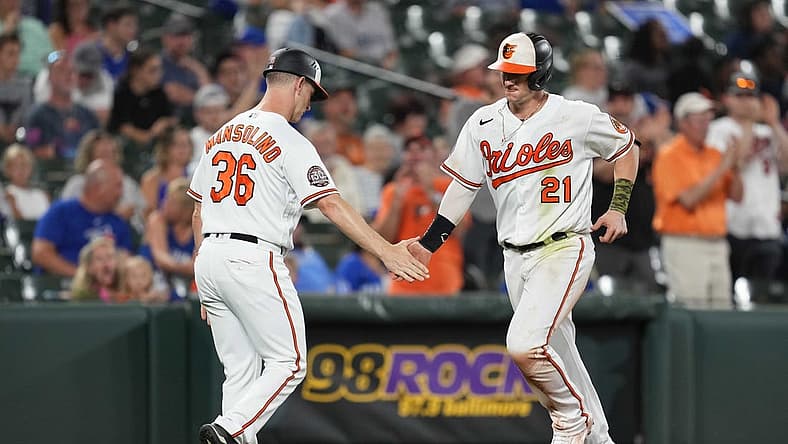 Aug 8, 2022; Baltimore, Maryland, USA; Baltimore Orioles outfielder Austin Hays (21) greeted by coach Tony Mansolino (36) after his solo home run in the sixth inning against the Toronto Blue Jays at Oriole Park at Camden Yards. Mandatory Credit: Mitch Stringer-USA TODAY Sports