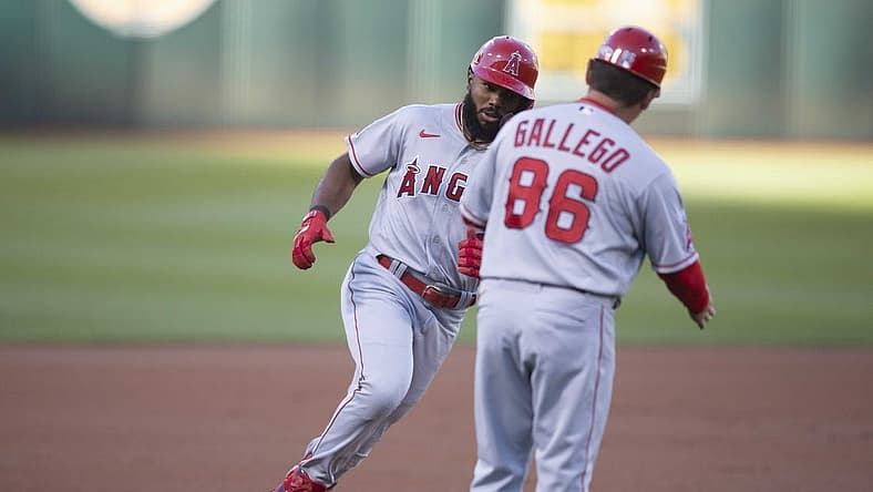 Aug 8, 2022; Oakland, California, USA; Los Angeles Angels second baseman Luis Rengifo (left) is greeted by third base coach Mike Gallego (86) after hitting a solo home run during the first inning at RingCentral Coliseum. Mandatory Credit: D. Ross Cameron-USA TODAY Sports