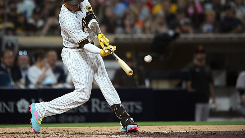 Aug 8, 2022; San Diego, California, USA; San Diego Padres third baseman Manny Machado (13) hits a single during the fourth inning against the San Francisco Giants at Petco Park. Mandatory Credit: Orlando Ramirez-USA TODAY Sports