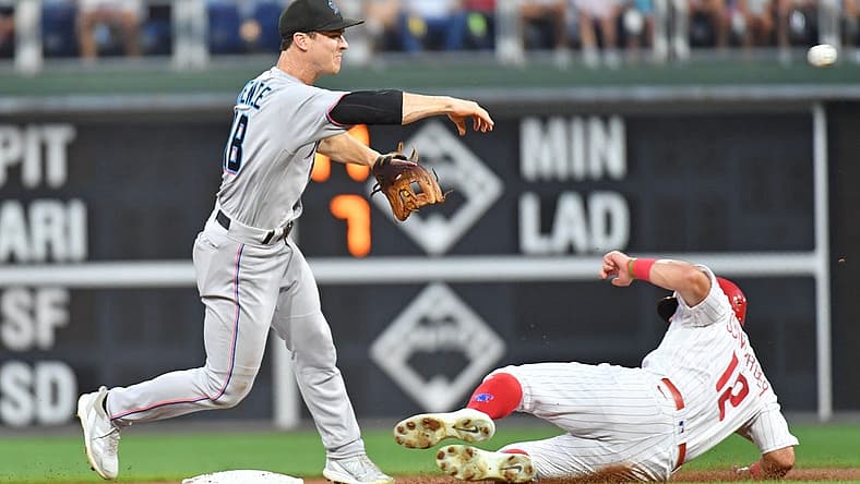 Aug 9, 2022; Philadelphia, Pennsylvania, USA; Miami Marlins second baseman Joey Wendle (18) gets force out on Philadelphia Phillies left fielder Kyle Schwarber (12) to and throes to first base to complete double play during the first inning at Citizens Bank Park. Mandatory Credit: Eric Hartline-USA TODAY Sports