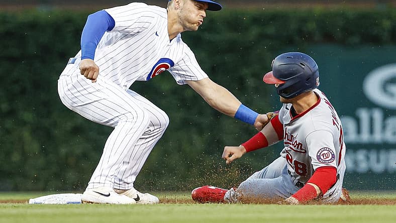 Aug 9, 2022; Chicago, Illinois, USA; Washington Nationals left fielder Lane Thomas (28) is caught stealing second base by Chicago Cubs shortstop Nico Hoerner (2) during the second inning at Wrigley Field. Mandatory Credit: Kamil Krzaczynski-USA TODAY Sports