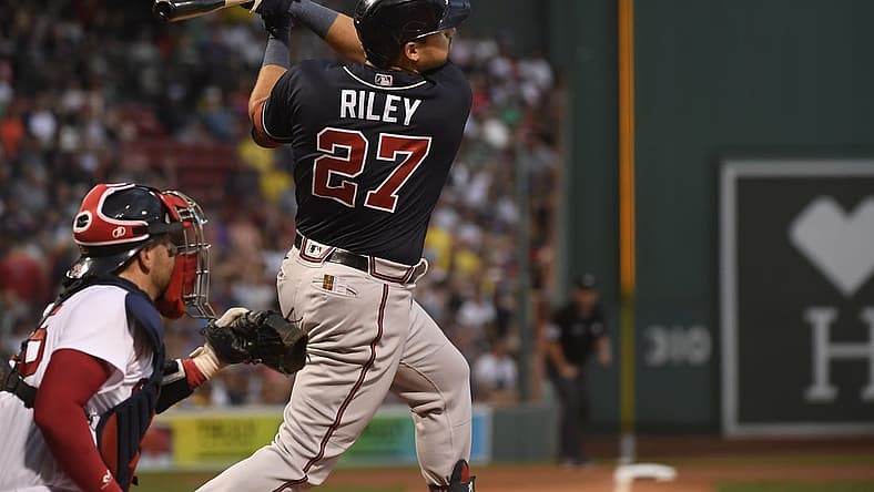 Aug 9, 2022; Boston, Massachusetts, USA; Atlanta Braves third baseman Austin Riley (27) hits an RBI triple during the first inning against the Boston Red Sox at Fenway Park. Mandatory Credit: Bob DeChiara-USA TODAY Sports