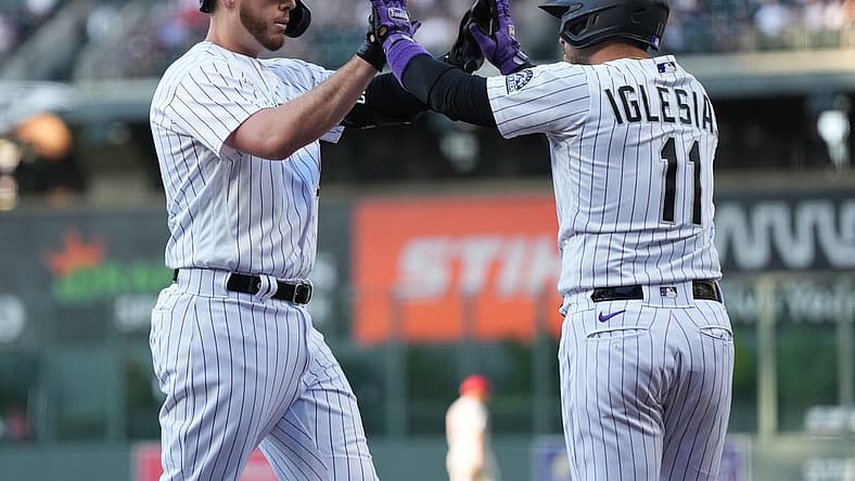 Aug 9, 2022; Denver, Colorado, USA; Colorado Rockies first baseman C.J. Cron (25) celebrates his three run home run with shortstop Jose Iglesias (11) in the first inning against the St. Louis Cardinals at Coors Field. Mandatory Credit: Ron Chenoy-USA TODAY Sports