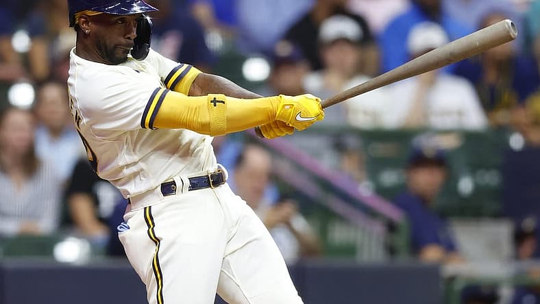 Aug 9, 2022; Milwaukee, Wisconsin, USA; Milwaukee Brewers designated hitter Andrew McCutchen (24) hits an RBI single during the fifth inning against the Tampa Bay Rays at American Family Field. Mandatory Credit: Jeff Hanisch-USA TODAY Sports