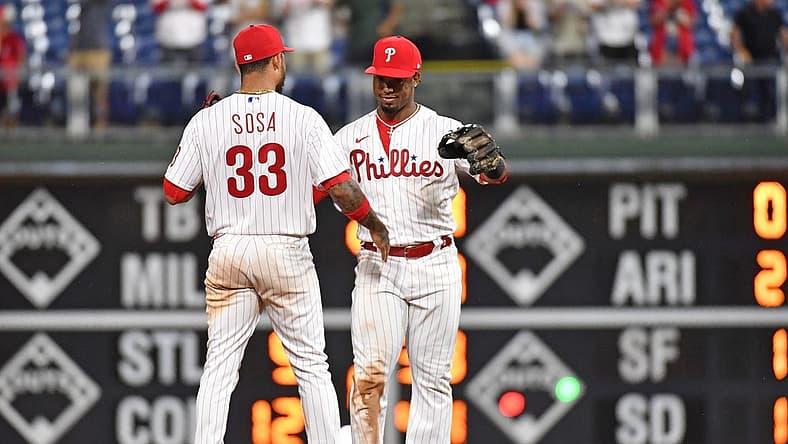 Aug 9, 2022; Philadelphia, Pennsylvania, USA; Philadelphia Phillies shortstop Edmundo Sosa (33) and second baseman Jean Segura (2) celebrate win against the Miami Marlins at Citizens Bank Park. Mandatory Credit: Eric Hartline-USA TODAY Sports