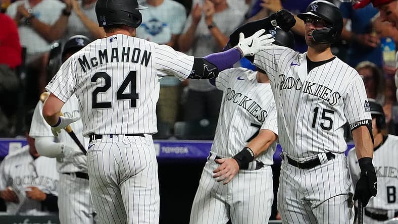 Aug 9, 2022; Denver, Colorado, USA; Colorado Rockies third baseman Ryan McMahon (24) celebrates his two run home run with right fielder Randal Grichuk (15) in the seventh inning against the St. Louis Cardinals at Coors Field. Mandatory Credit: Ron Chenoy-USA TODAY Sports