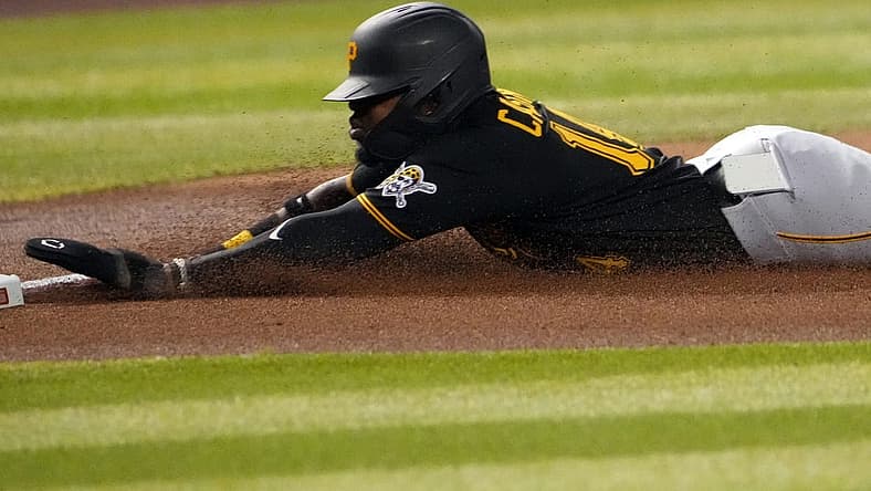 Aug 9, 2022; Phoenix, Arizona, USA; Pittsburgh Pirates second baseman Rodolfo Castro (14) loses his iPhone as he slides into third base against the Arizona Diamondbacks during the fourth inning at Chase Field. Mandatory Credit: Joe Camporeale-USA TODAY Sports