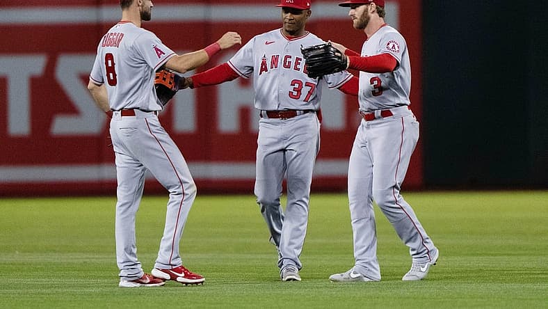 Aug 9, 2022; Oakland, California, USA; Los Angeles Angels left fielder Steven Duggar (8) , center fielder Magneuris Sierra (37) and right fielder Taylor Ward (3) celebrate after defeating the Oakland Athletics at RingCentral Coliseum. Mandatory Credit: Stan Szeto-USA TODAY Sports