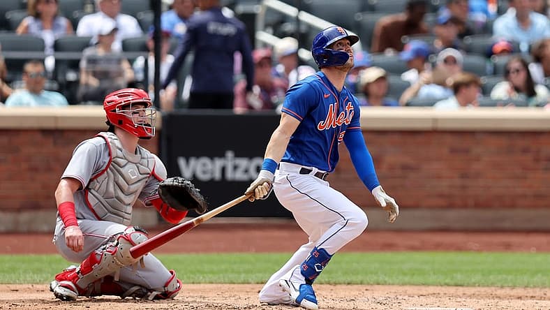 Aug 10, 2022; New York City, New York, USA; New York Mets right fielder Tyler Naquin (25) follows through on a solo home run against the Cincinnati Reds during the third inning at Citi Field. Mandatory Credit: Brad Penner-USA TODAY Sports