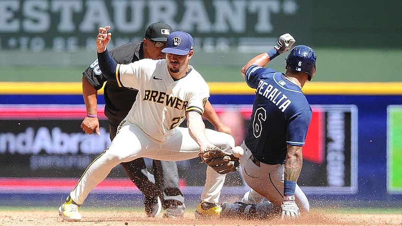 Aug 10, 2022; Milwaukee, Wisconsin, USA; Milwaukee Brewers shortstop Willy Adames (27) is unable make the play as Tampa Bay Rays left fielder David Peralta (6) slides in safely in the third inning  at American Family Field. Mandatory Credit: Michael McLoone-USA TODAY Sports