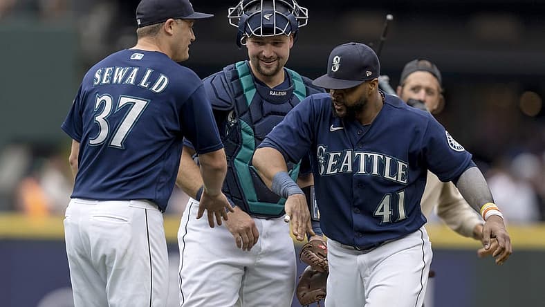 Aug 10, 2022; Seattle, Washington, USA; Seattle Mariners relief pitcher Paul Sewald (37), catcher Cal Raleigh (29) and designated hitter Carlos Santana (41) celebrate after a game against the New York Yankees at T-Mobile Park. Mandatory Credit: Stephen Brashear-USA TODAY Sports
