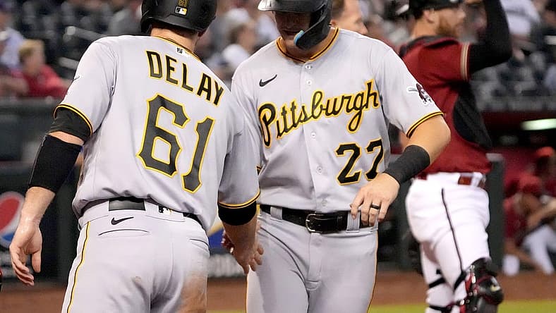 Aug 10, 2022; Phoenix, Arizona, USA; Pittsburgh Pirates catcher Jason Delay (61) and shortstop Kevin Newman (27) celebrate after scoring runs against the Arizona Diamondbacks during the third inning at Chase Field. Mandatory Credit: Joe Camporeale-USA TODAY Sports