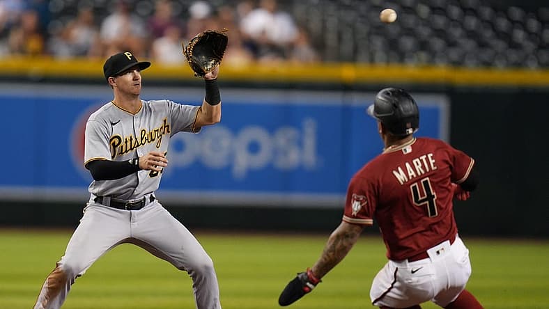 Aug 10, 2022; Phoenix, Ariz., USA; Arizona Diamondbacks' Ketel Marte slides in as Pittsburgh Pirates' Kevin Newman catches the ball for an out at Chase Field. Mandatory Credit: Joe Rondone-Arizona Republic

Mlb Pirates At Diamondbacks