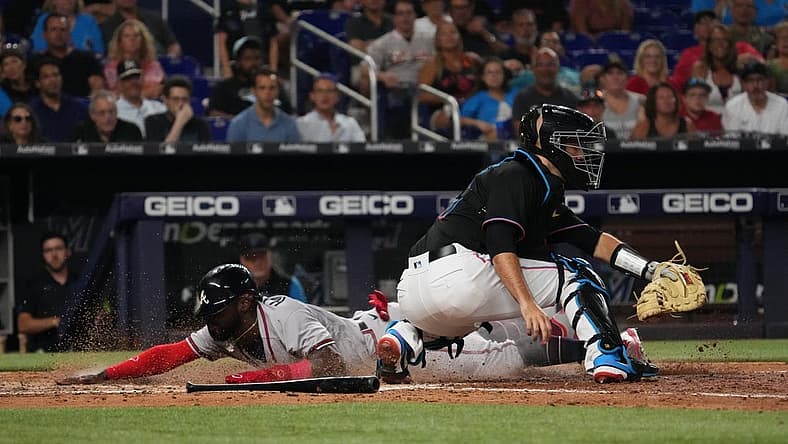 Aug 12, 2022; Miami, Florida, USA; Atlanta Braves center fielder Michael Harris II (23) scores a run behind Miami Marlins catcher Jacob Stallings (58) on the sac fly of shortstop Dansby Swanson (not pictured) in the sixth inning at loanDepot park. Mandatory Credit: Jasen Vinlove-USA TODAY Sports