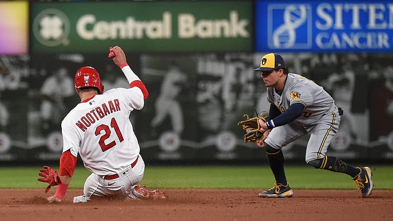 Aug 12, 2022; St. Louis, Missouri, USA; St. Louis Cardinals right fielder Lars Nootbaar (21) steals second base ahead of Milwaukee Brewers second baseman Luis Urias (2) in the fifth inning at Busch Stadium. Mandatory Credit: Joe Puetz-USA TODAY Sports