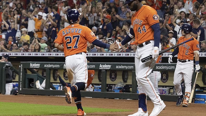 Aug 12, 2022; Houston, Texas, USA; Houston Astros designated hitter Yordan Alvarez (44) celebrates second baseman Jose Altuve (27) run against the Oakland Athletics in the fifth inning at Minute Maid Park. Mandatory Credit: Thomas Shea-USA TODAY Sports