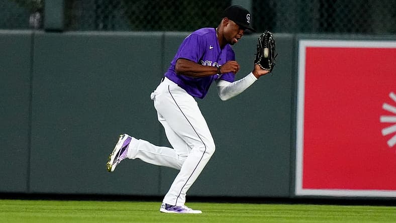 Aug 12, 2022; Denver, Colorado, USA; Colorado Rockies center fielder Wynton Bernard (36) fields the ball the sixth inning against the Arizona Diamondbacks at Coors Field. Mandatory Credit: Ron Chenoy-USA TODAY Sports