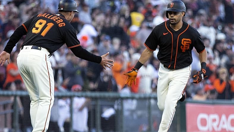 Aug 13, 2022; San Francisco, California, USA; San Francisco Giants designated hitter LaMonte Wade Jr. (right) celebrates with third base coach Mark Hallberg (91) after hitting a solo home run against the Pittsburgh Pirates in the third inning at Oracle Park. Mandatory Credit: D. Ross Cameron-USA TODAY Sports