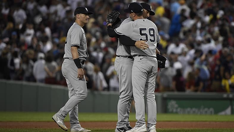 Aug 13, 2022; Boston, Massachusetts, USA; New York Yankees relief pitcher Scott Effross (59) is congratulated by first baseman Anthony Rizzo (48) after defeating the Boston Red Sox at Fenway Park. Mandatory Credit: Bob DeChiara-USA TODAY Sports