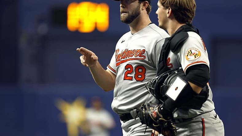 Aug 14, 2022; St. Petersburg, Florida, USA;Baltimore Orioles starting pitcher Jordan Lyles (28) and catcher Adley Rutschman (35) talk against the Tampa Bay Rays at the end of the first inning at Tropicana Field. Mandatory Credit: Kim Klement-USA TODAY Sports