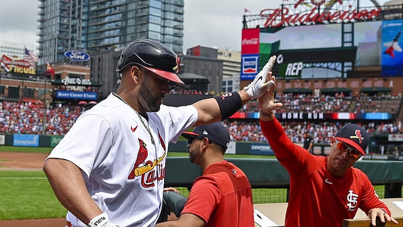 Aug 14, 2022; St. Louis, Missouri, USA; St. Louis Cardinals designated hitter Albert Pujols (5) celebrates with bench coach Skip Schumaker (55) after hitting a solo home run against the Milwaukee Brewers during the second inning at Busch Stadium. Mandatory Credit: Jeff Curry-USA TODAY Sports